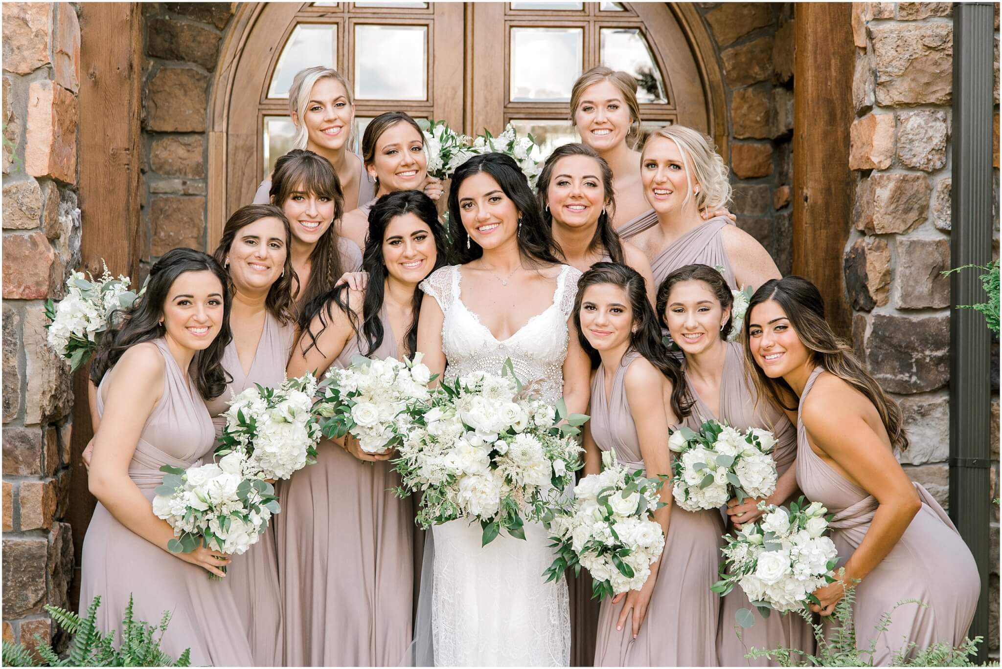 Large bridal party with neutral toned bridesmaid dresses