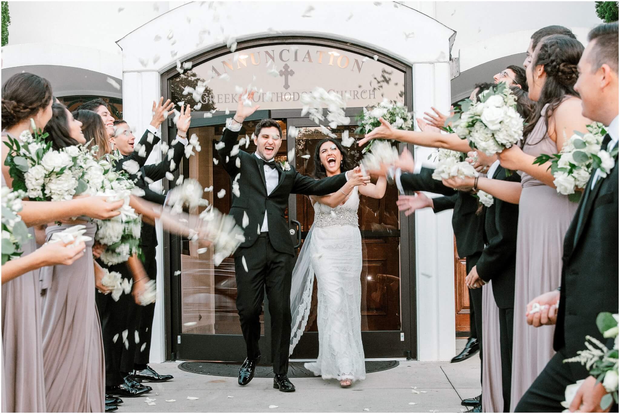 Bridal party throwing confetti at newly married couple