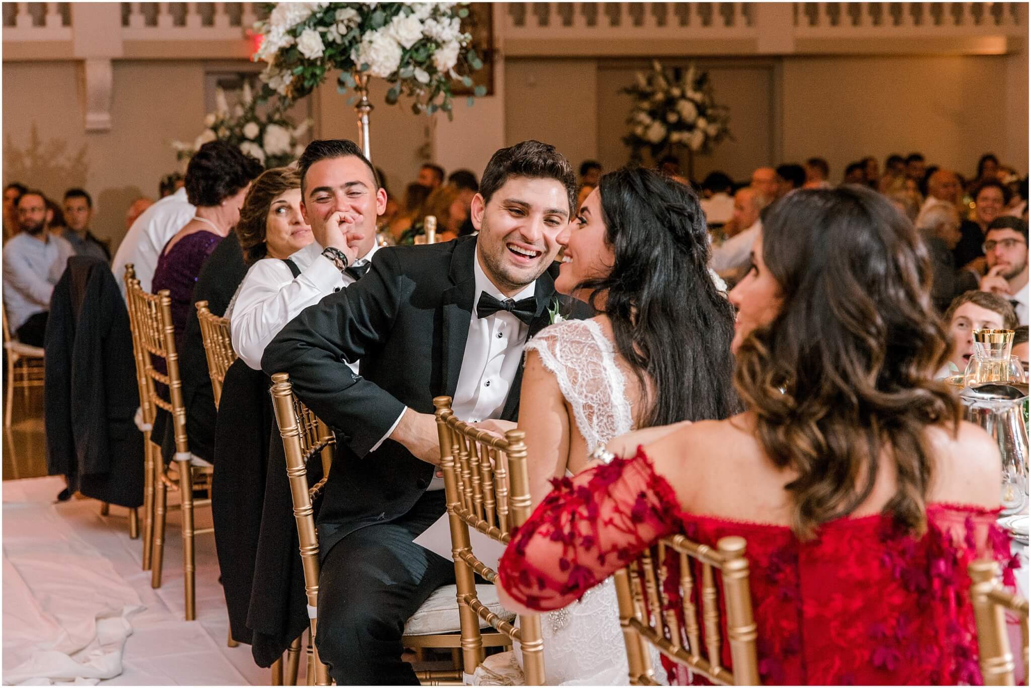 Groom laughs during wedding toast