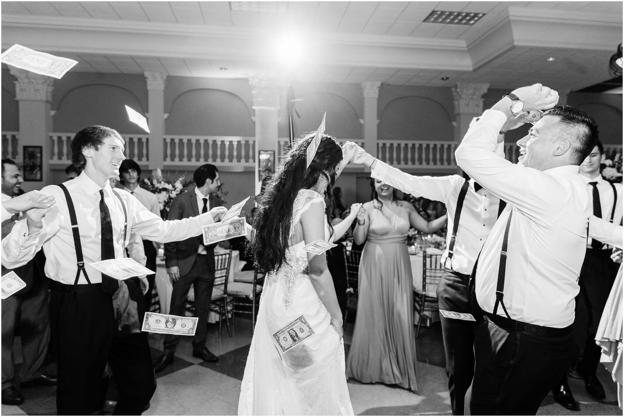 Greek wedding reception dancing with money thrown in the air