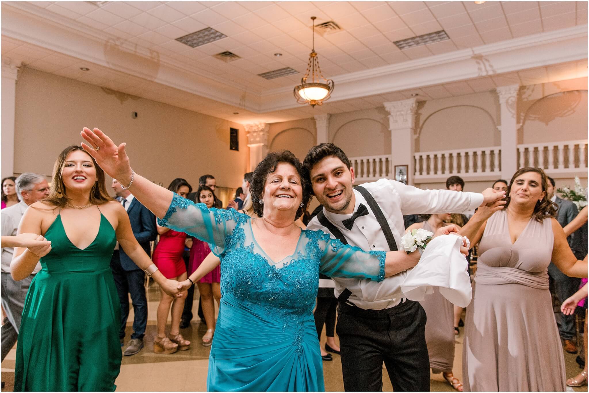 Grew takes a picture with grandma at wedding reception