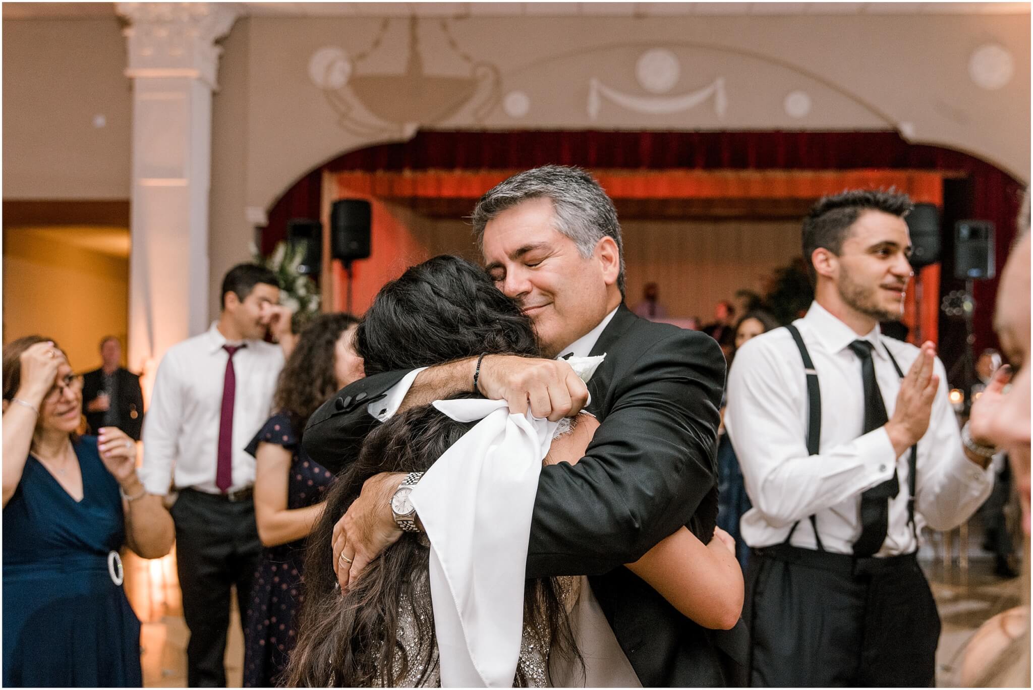 Dad hugging bride at a wedding reception in Winston-Salem