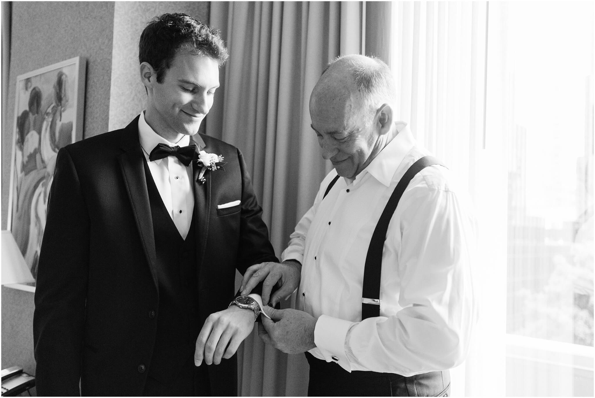 father helping groom get ready in charlotte hotel