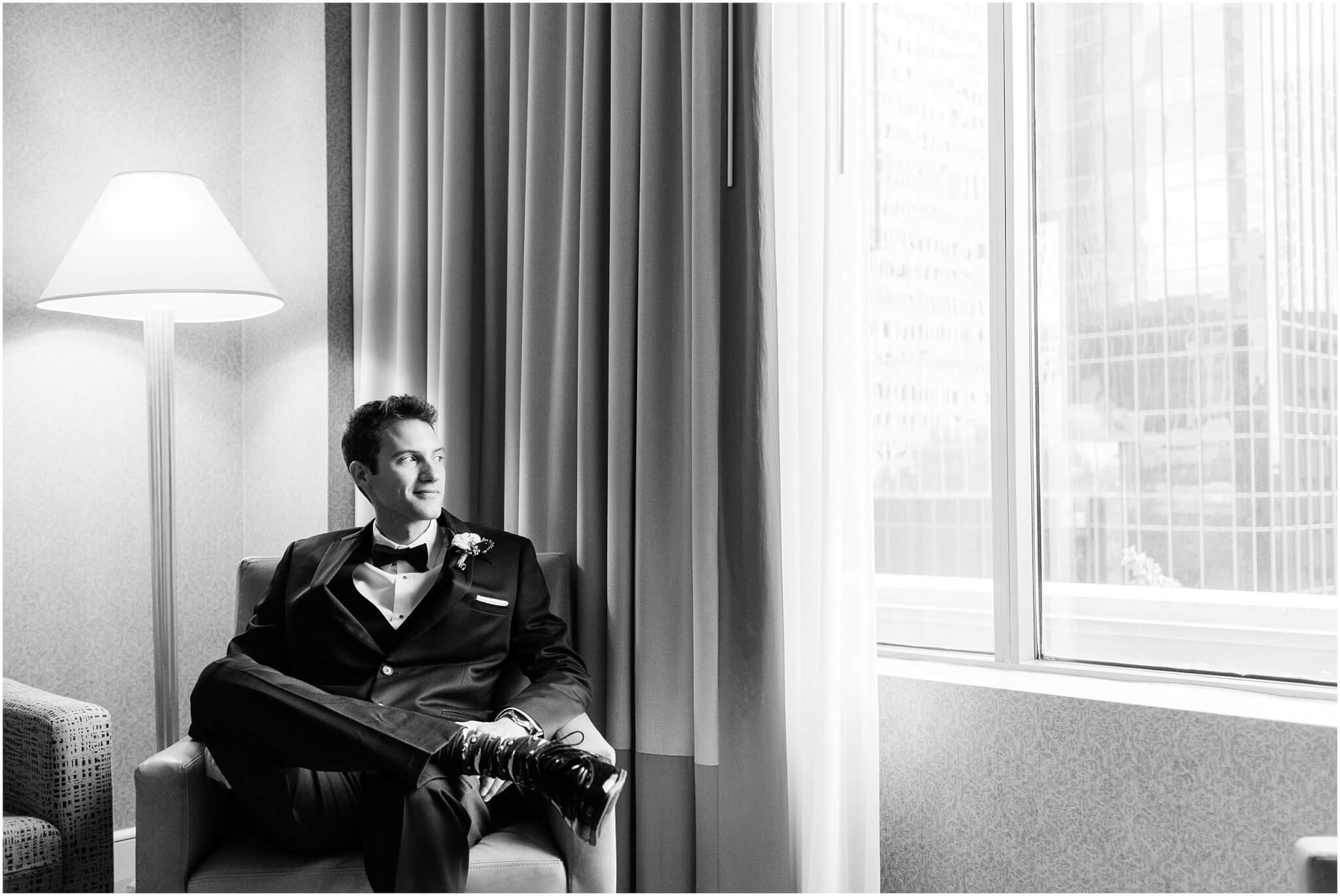groom waiting in hotel room before charlotte wedding