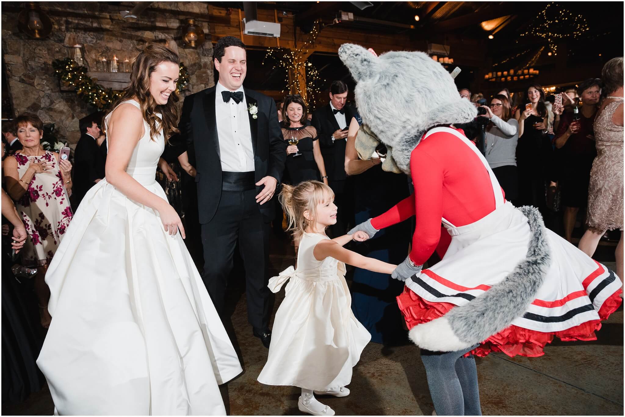 nc state mascot dances with little girl at raleigh wedding