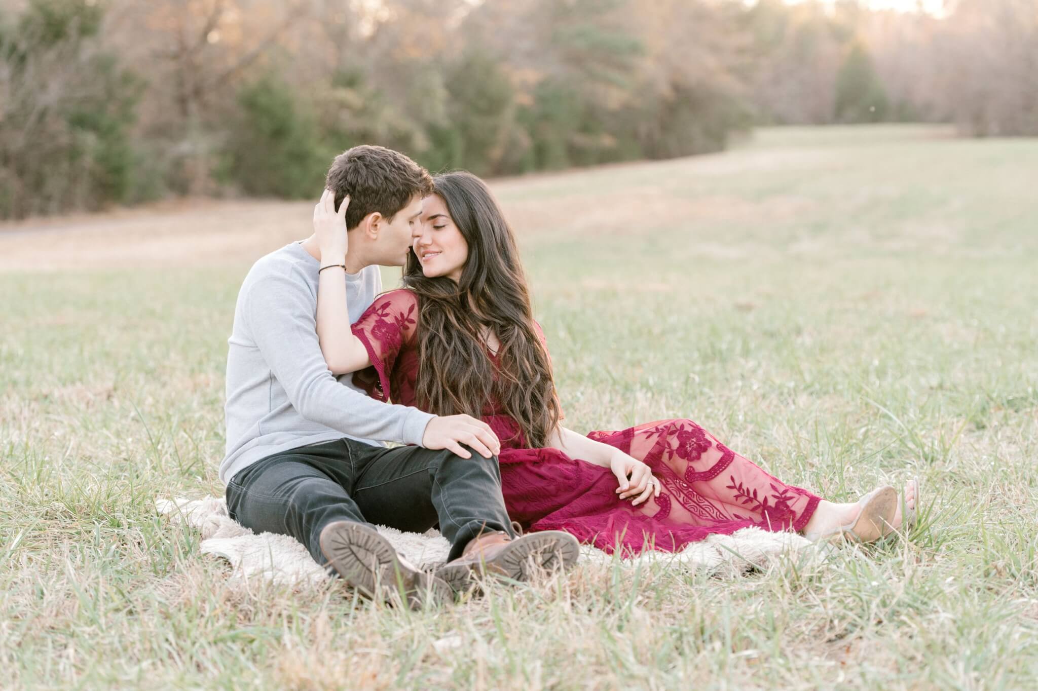 couple sitting on blanket at engagement session