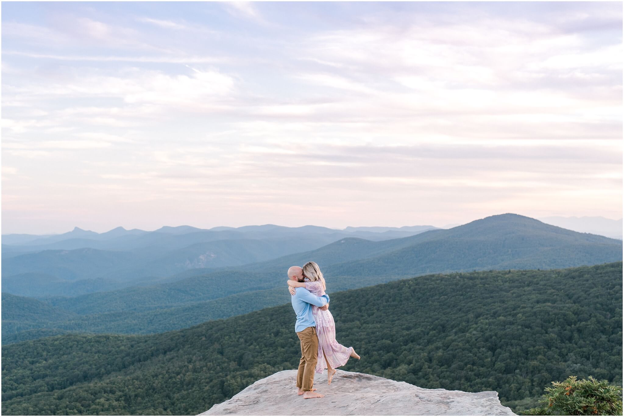 couple twirling on mountain ledge, north carolina wedding photographer