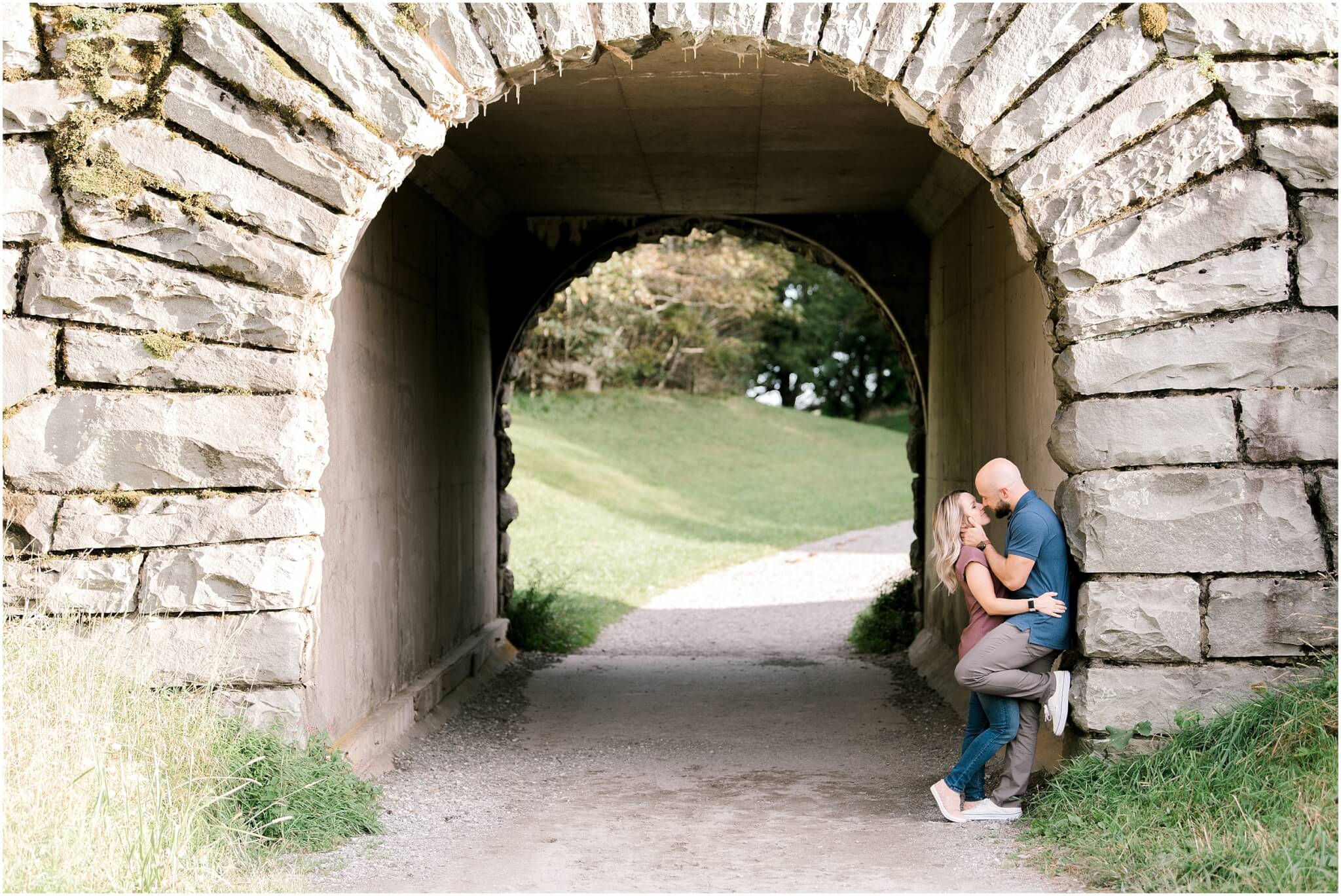 couple kissing under bridge, blue ridge mountain engagement session, north carolina wedding photographer