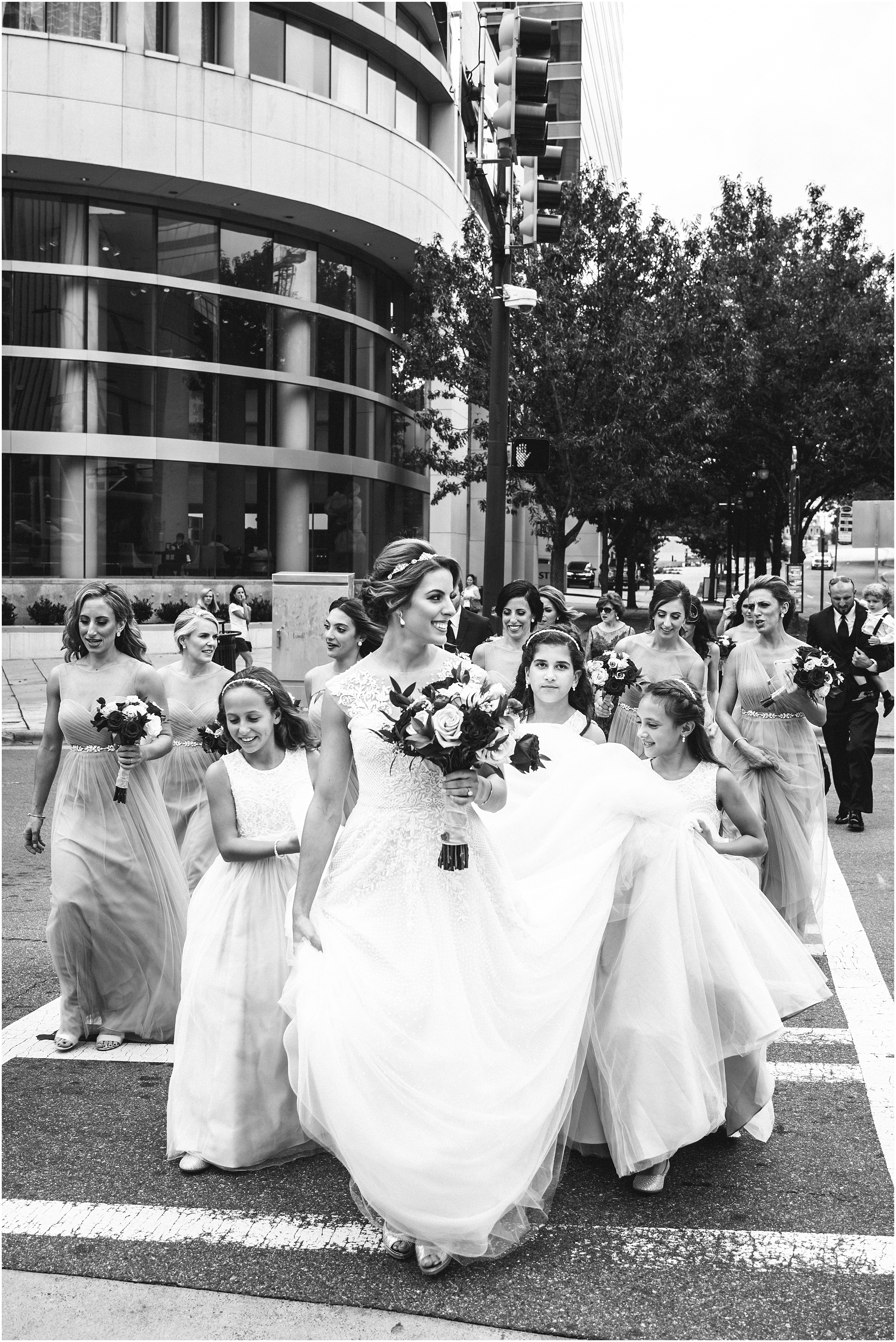 greek orthodox wedding party crossing the street