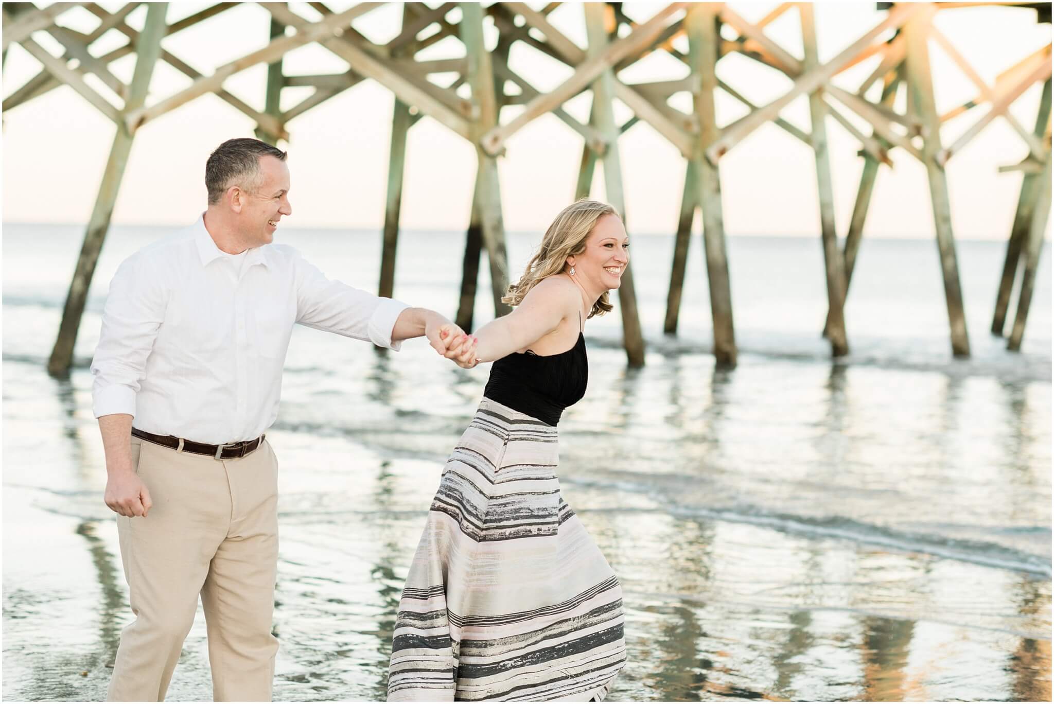couple laughing on the beach, south carolina wedding photographer