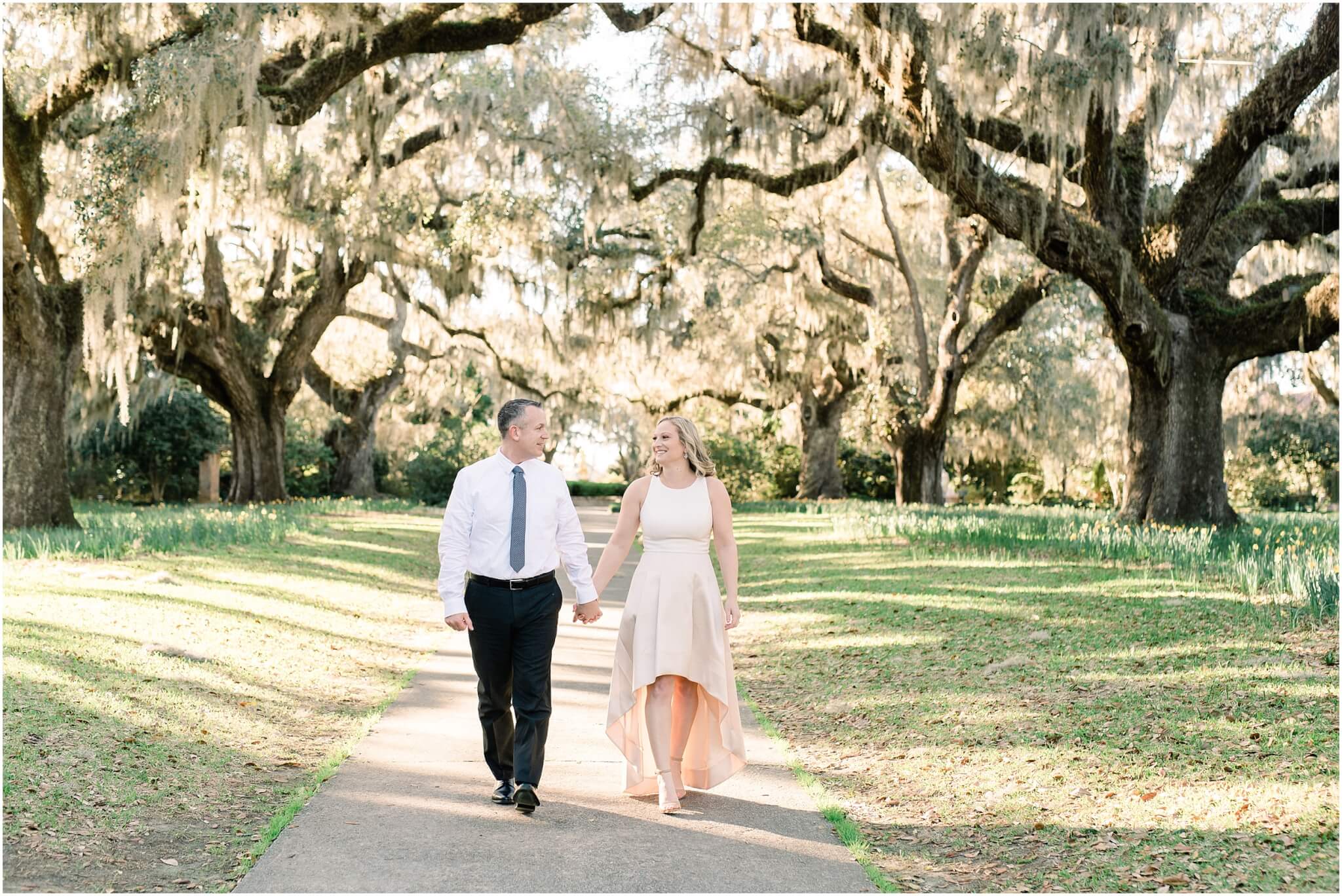 engaged couple walking under live oak, south carolina wedding photographer