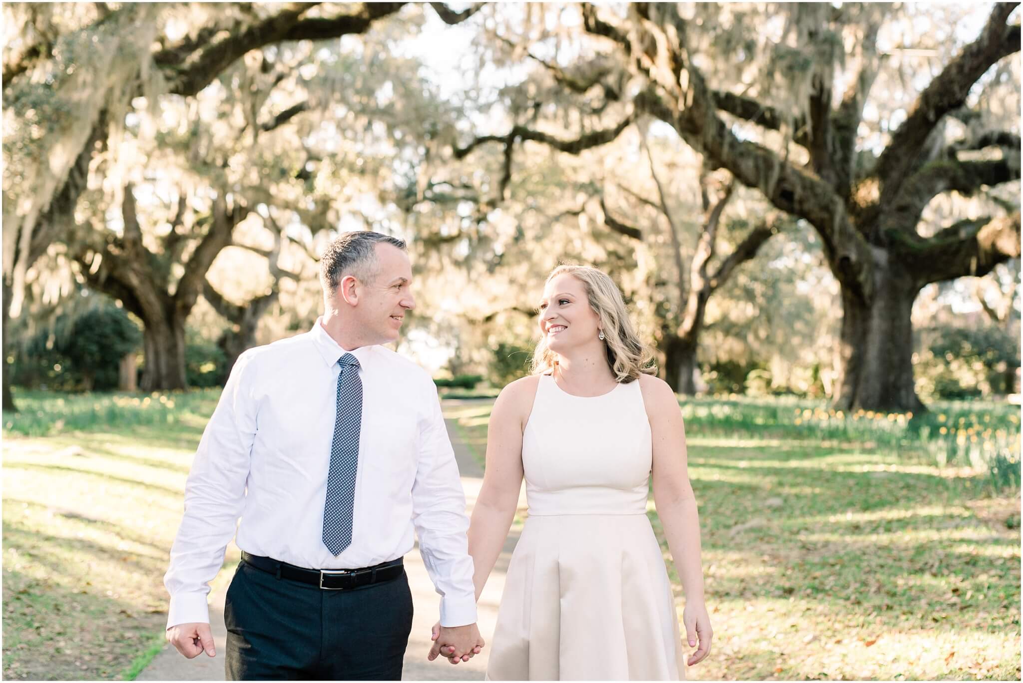 engaged couple walking under live oak, south carolina wedding photographer