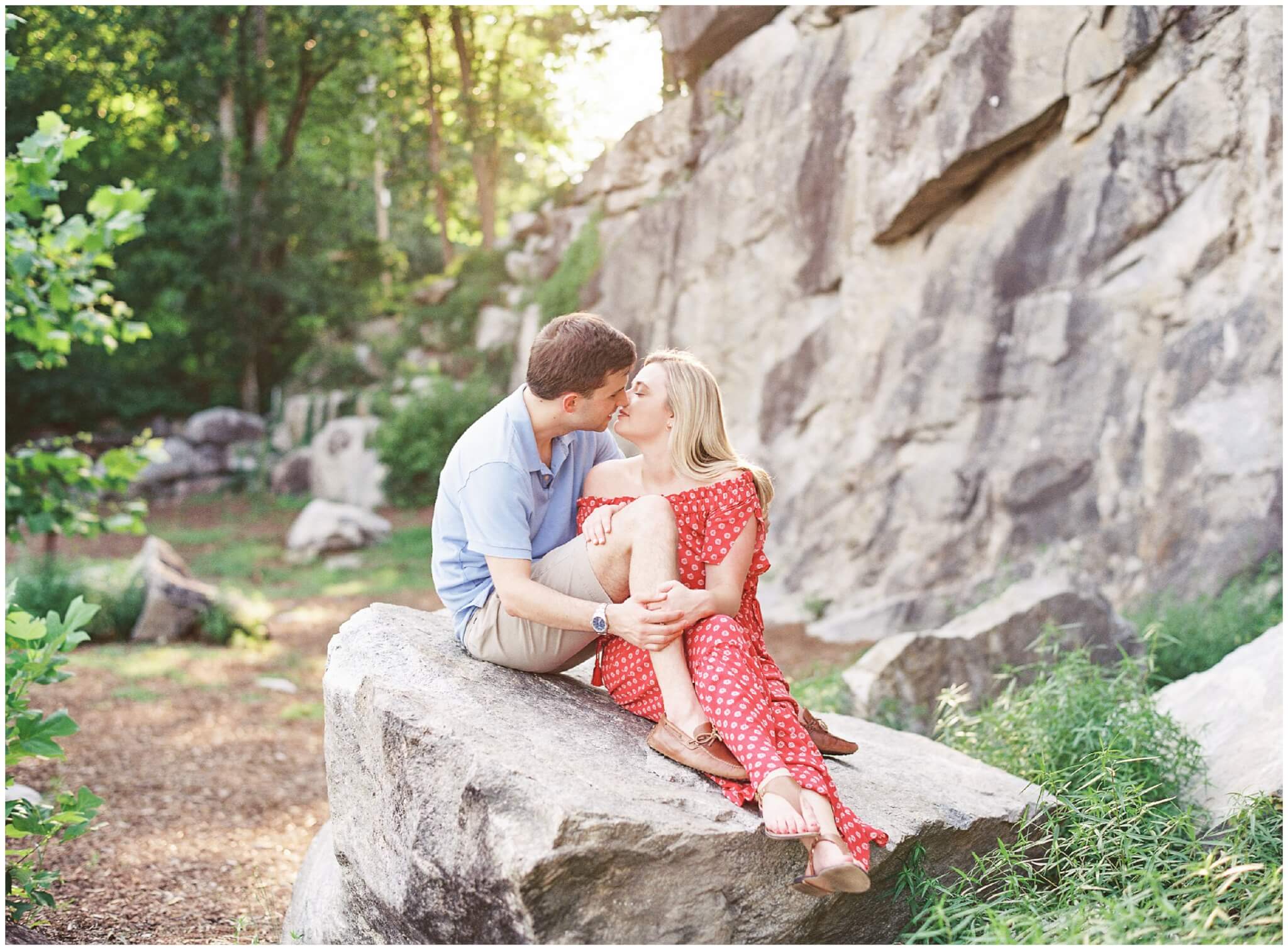 Couple kissing on rock in NC quarry