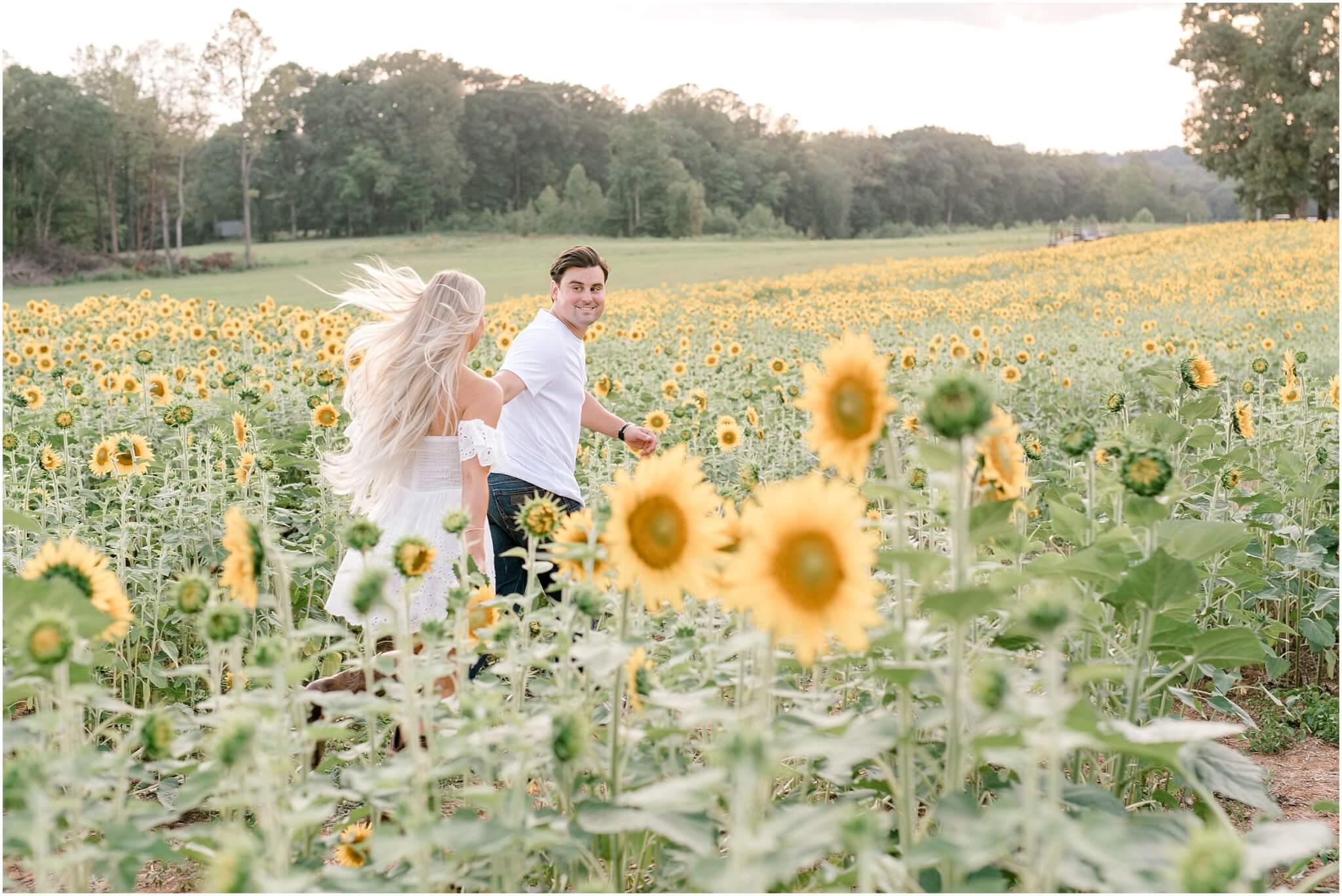 couple running in sunflower field, north carolina wedding photographer