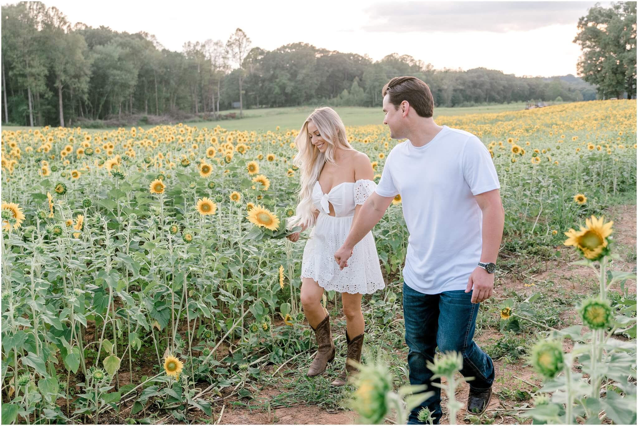 couple running in sunflower field, north carolina wedding photographer