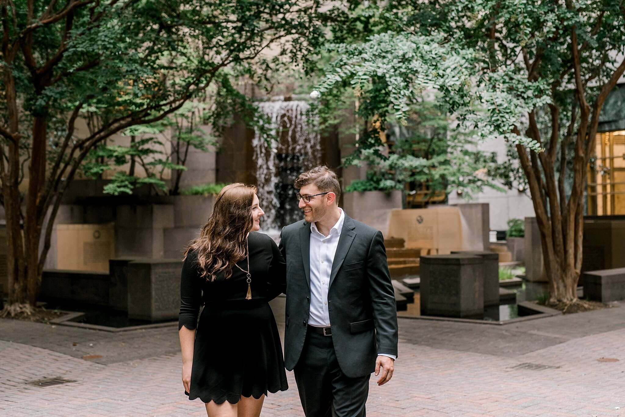 engaged couple walking uptown charlotte engagement session