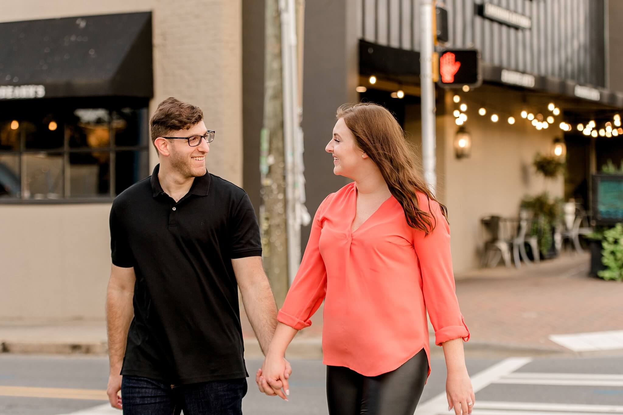 couple walking on charlotte street for engagement photos