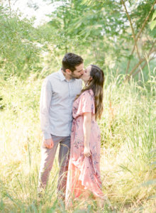 Couple kissing in grassy field