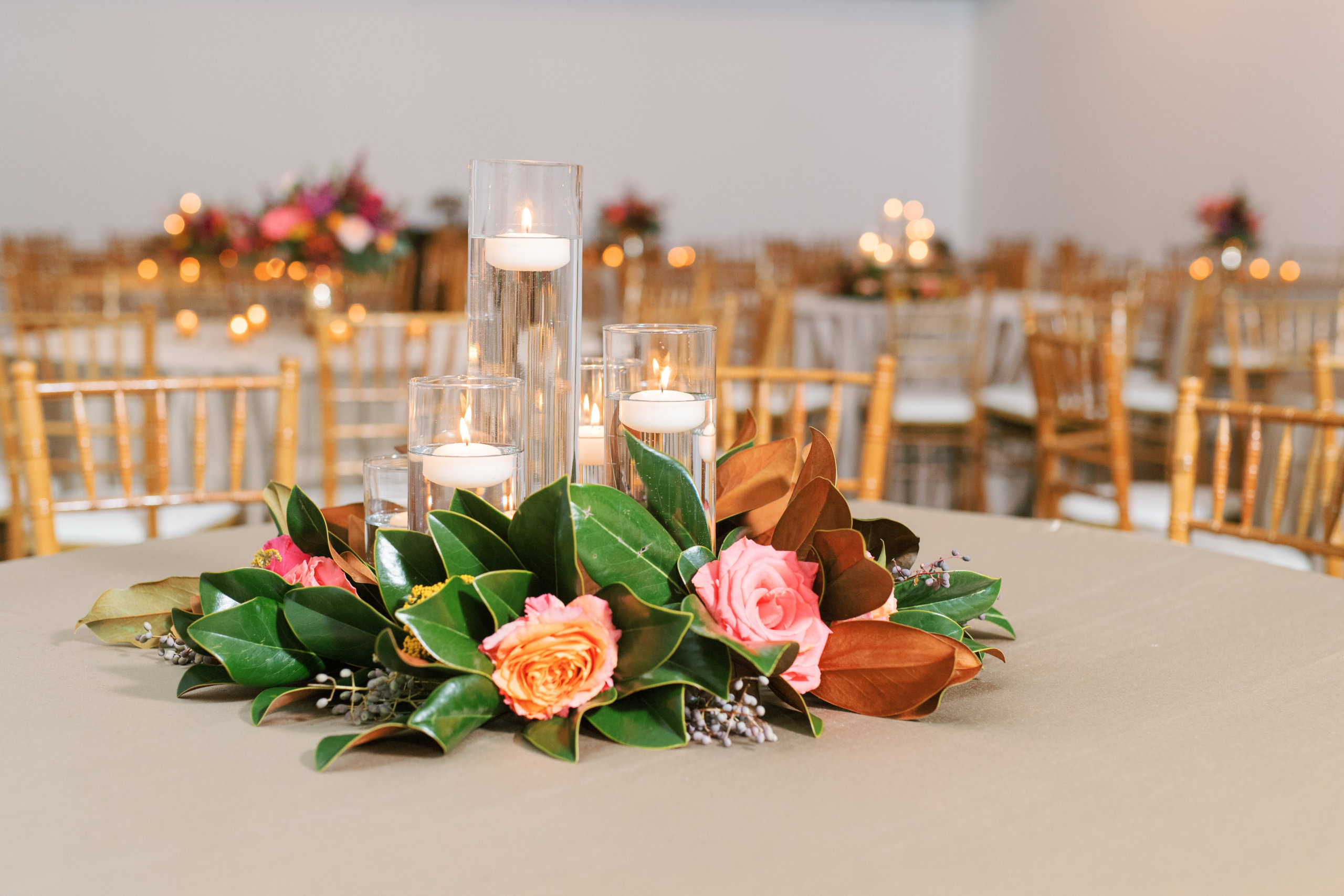 Wedding reception table with greenery and floating candles