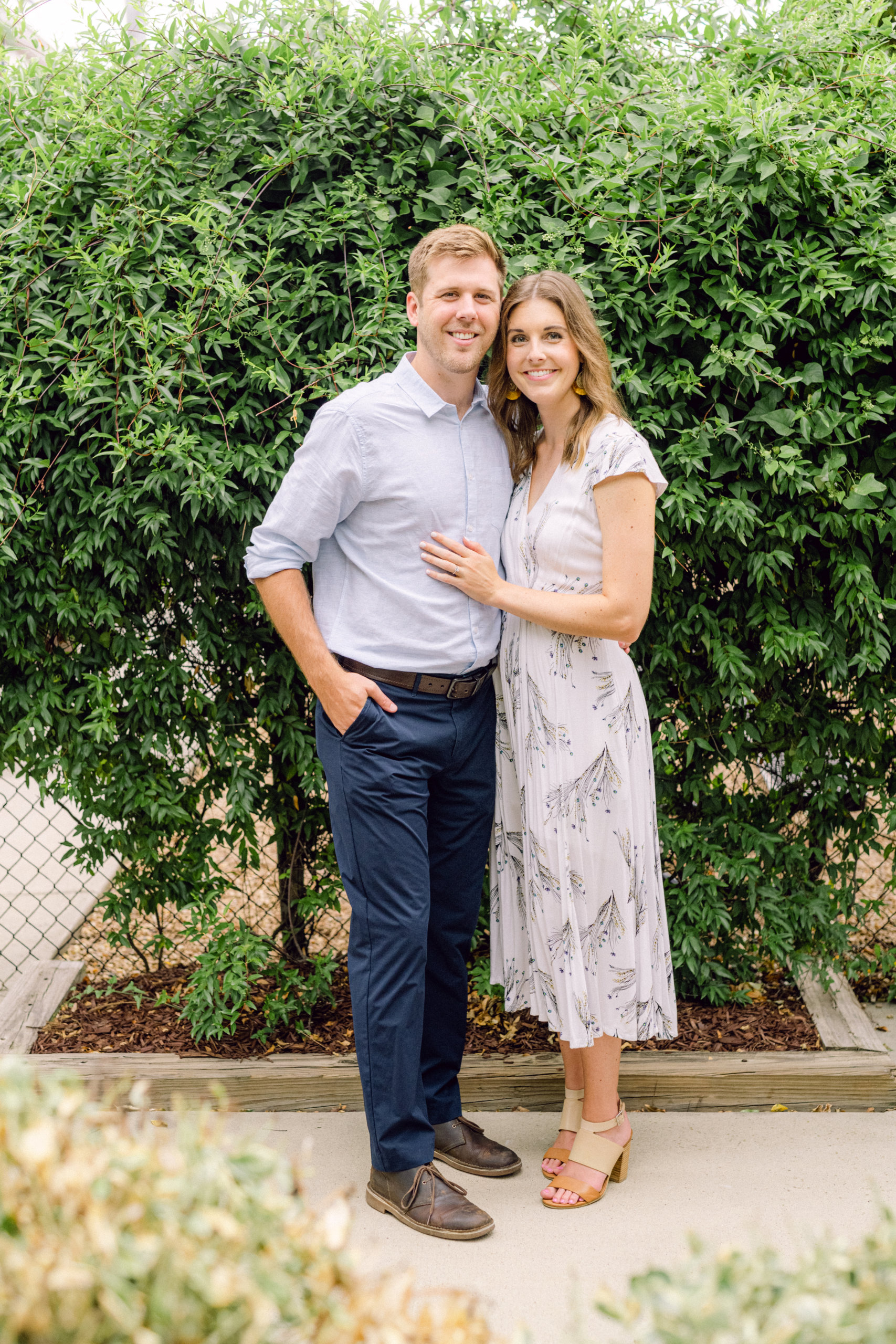 Couple smiling wearing modern spring wedding guest outfits