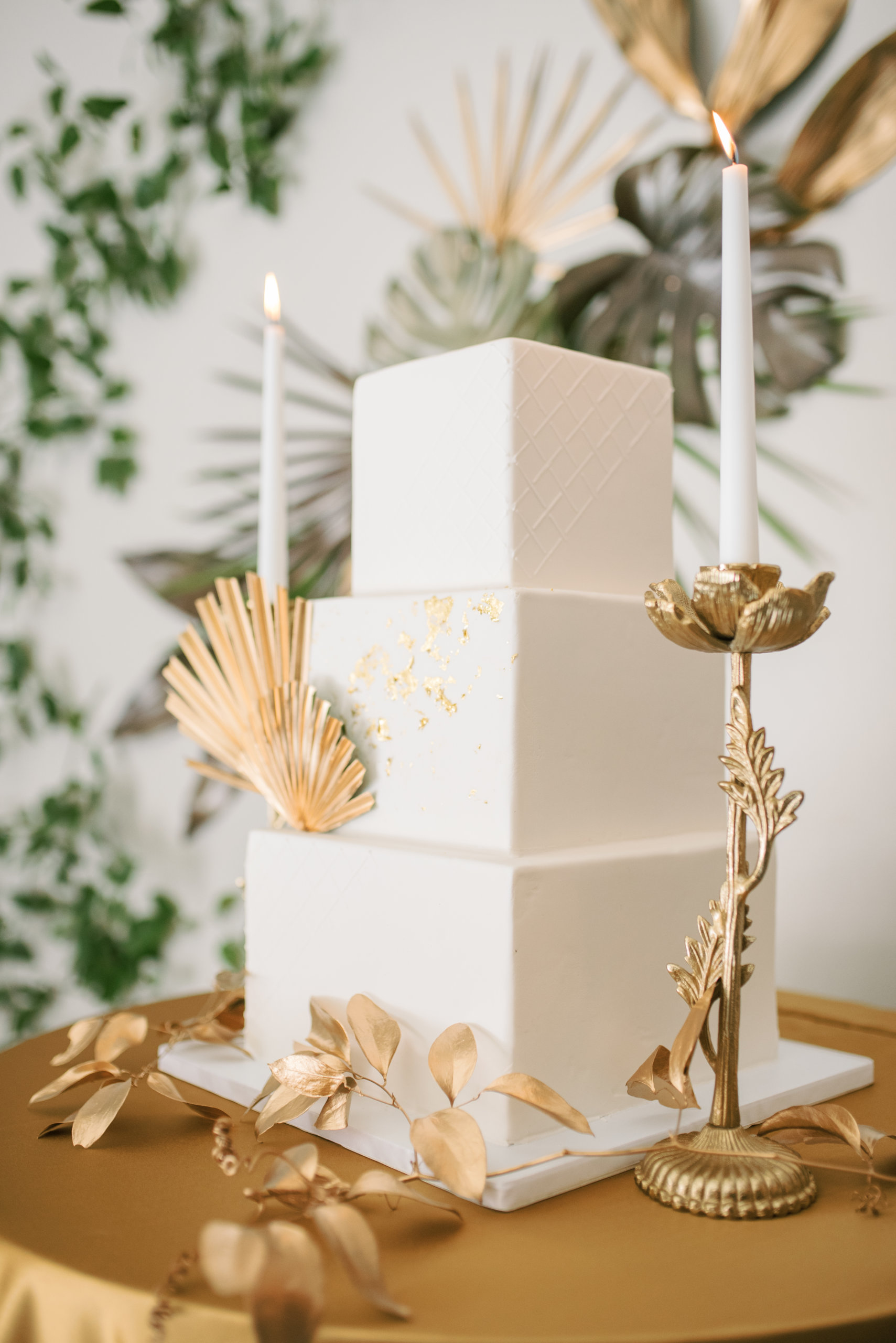 Wedding cake with gold details and candles