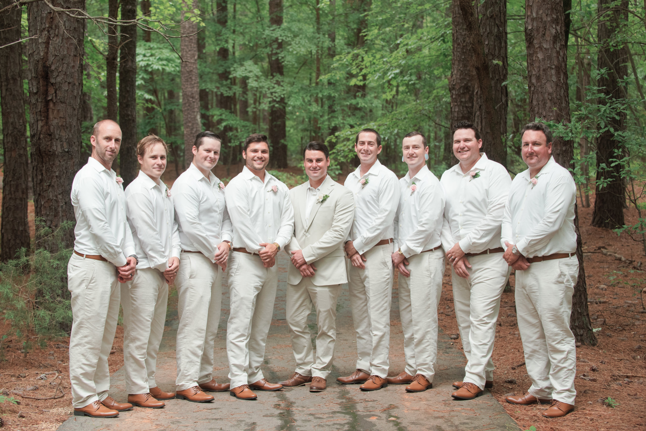 Groom and groomsmen in white button up shirts and khaki pants