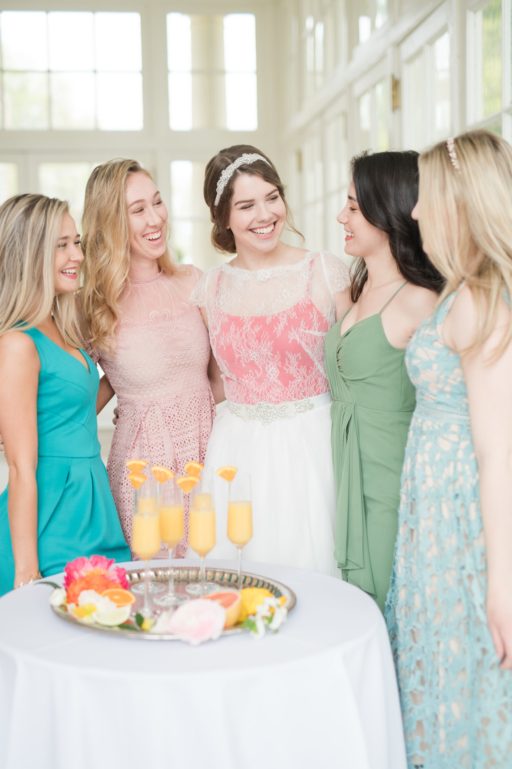 bride and bridesmaids smiling at summer bridal brunch