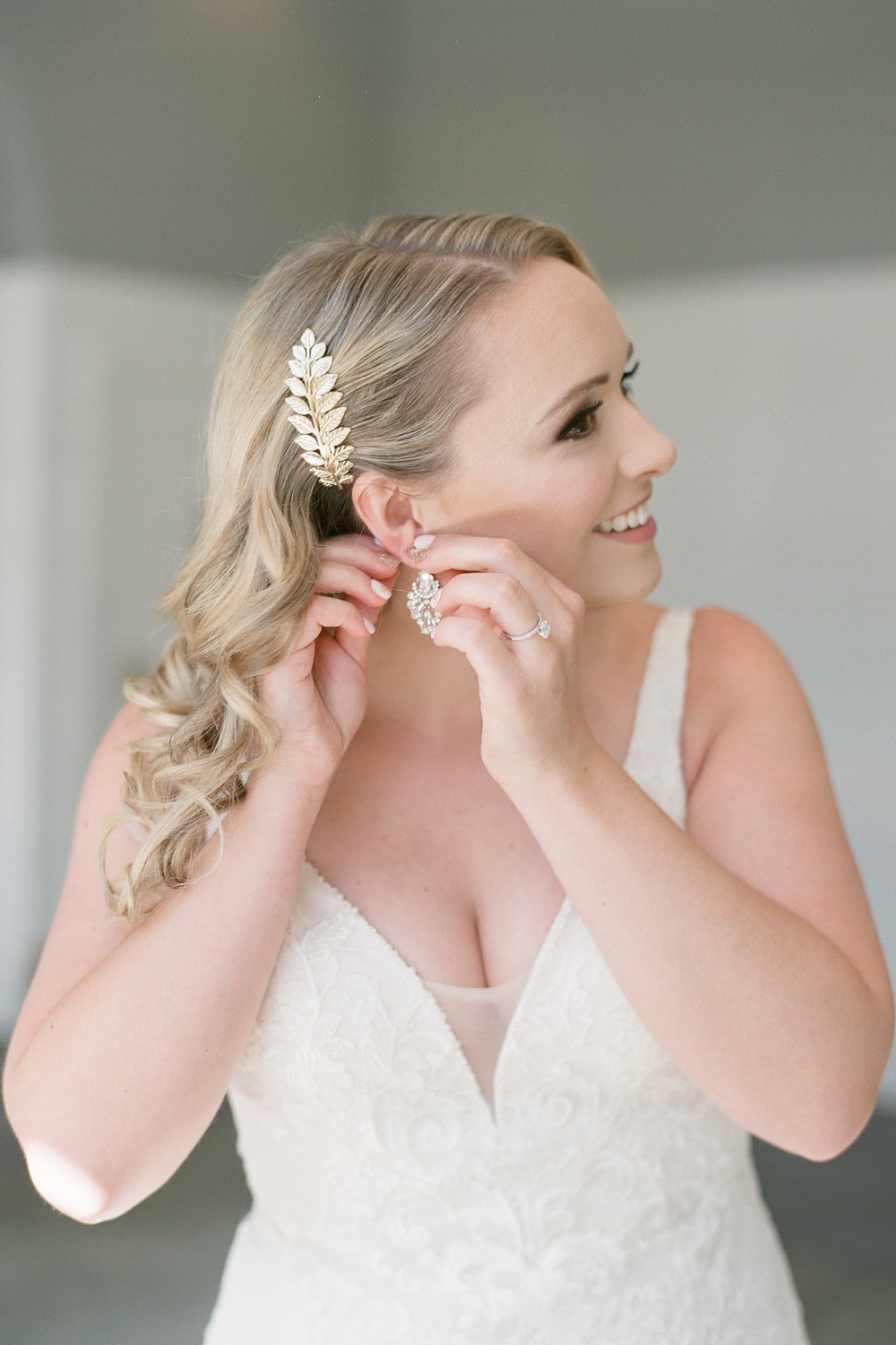 Bride with gold leaf shaped clip and diamond earring