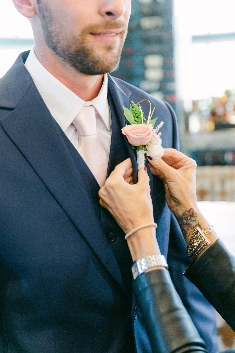 Groom getting ready for wedding with boutonniere