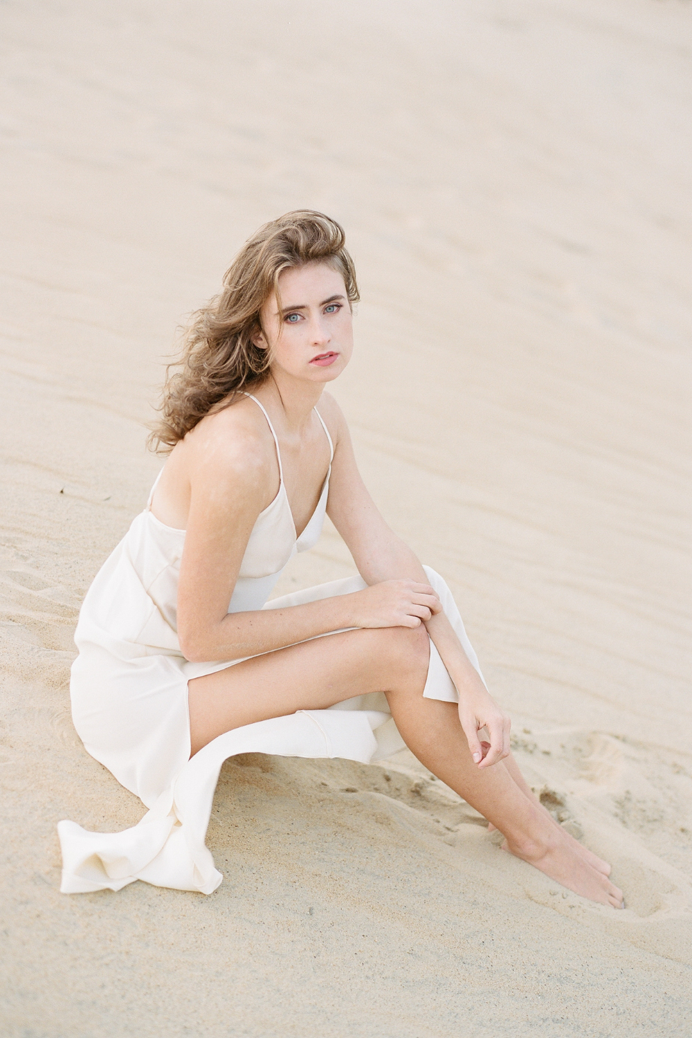 Bride in slip dress on sand at beach wedding at Outer Banks