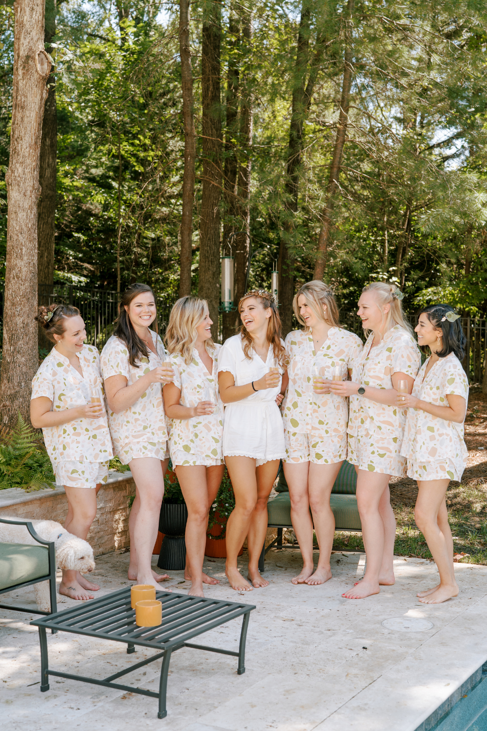 Bride with bridesmaids getting ready for wedding day with drinks