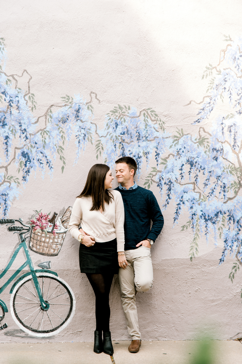 Winter engagement session photography in North Carolina in front of mural