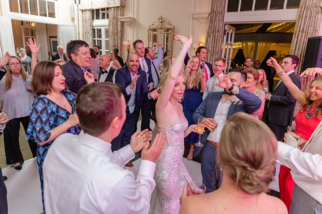 Bride and groom dancing with guests at wedding reception in North Carolina