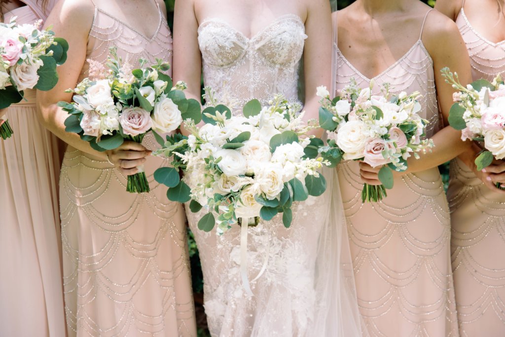 bride and bridesmaids holding white bouquets for romantic Charlotte wedding