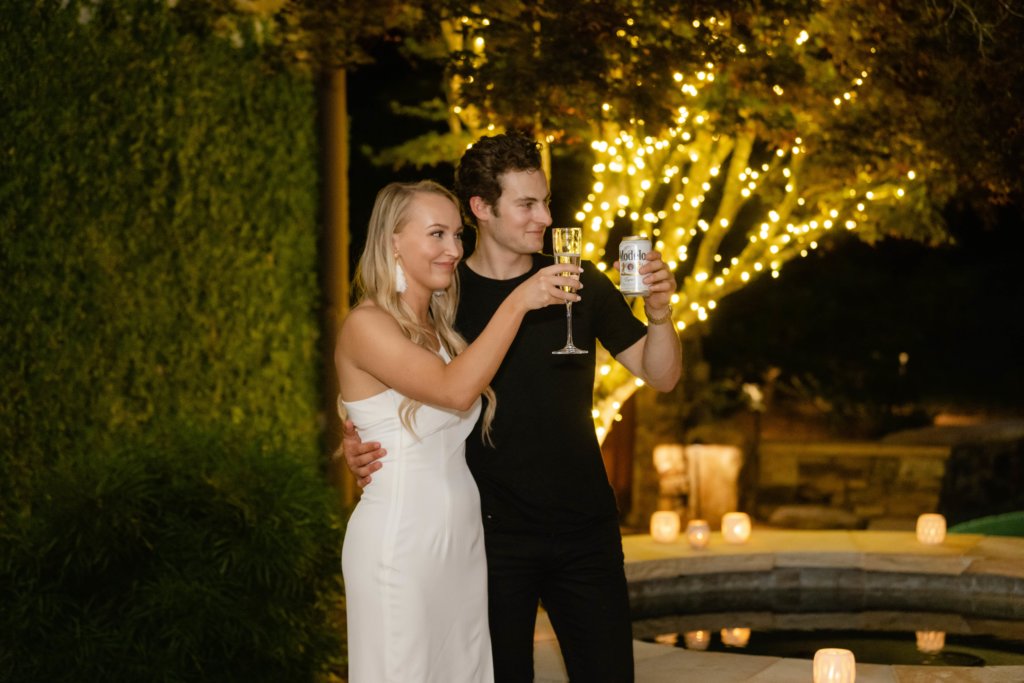 Couple toasting at backyard engagement party
